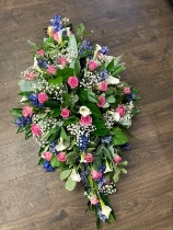 Pink white and blue casket spray